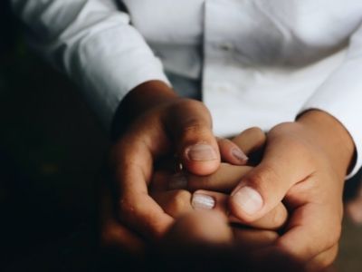 Two people sitting and holding hands CISOs mental health